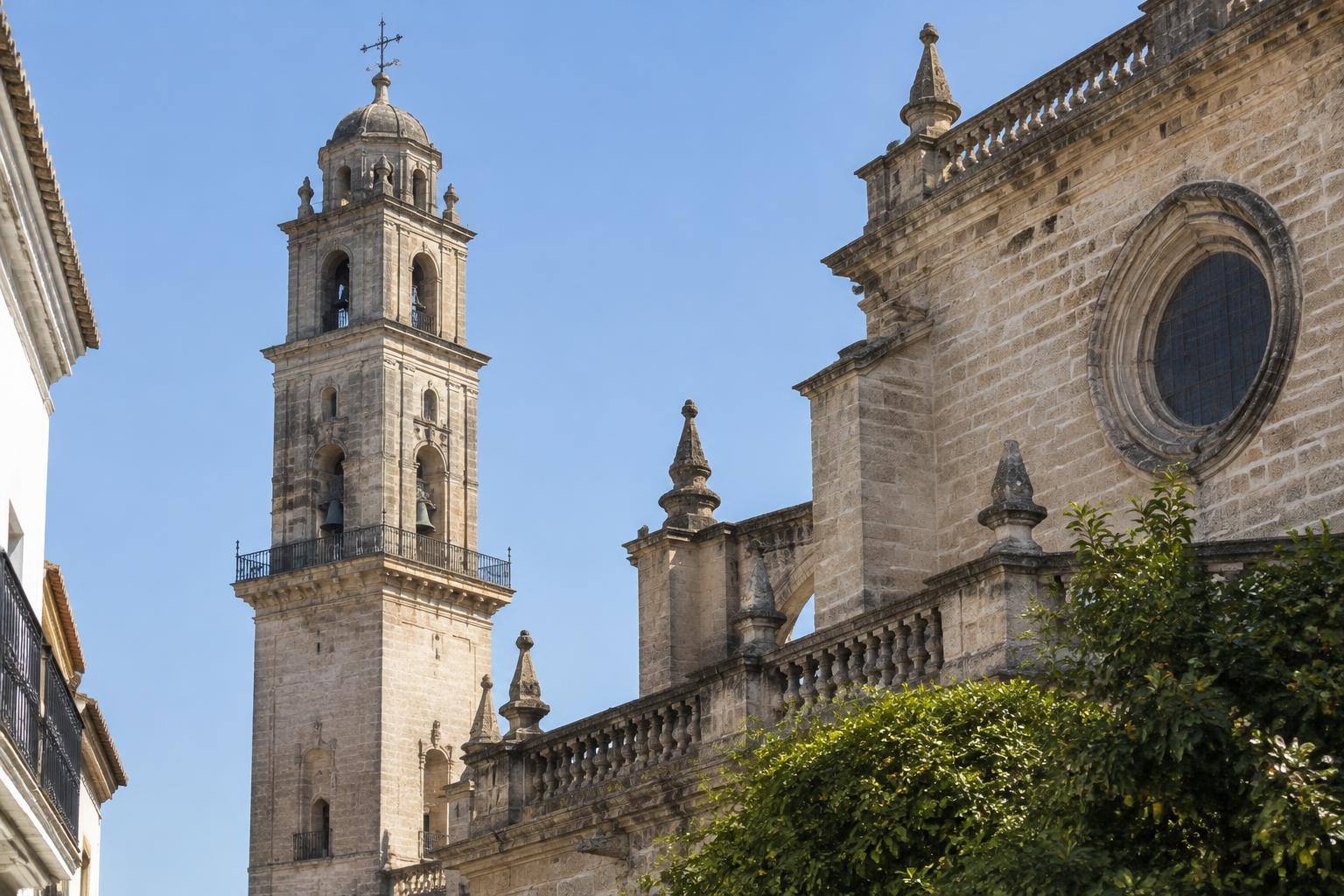 Imagen ilustrativa: Detalle de una torre histórica de piedra junto a una iglesia, sin personas ni elementos de reconstrucción digital