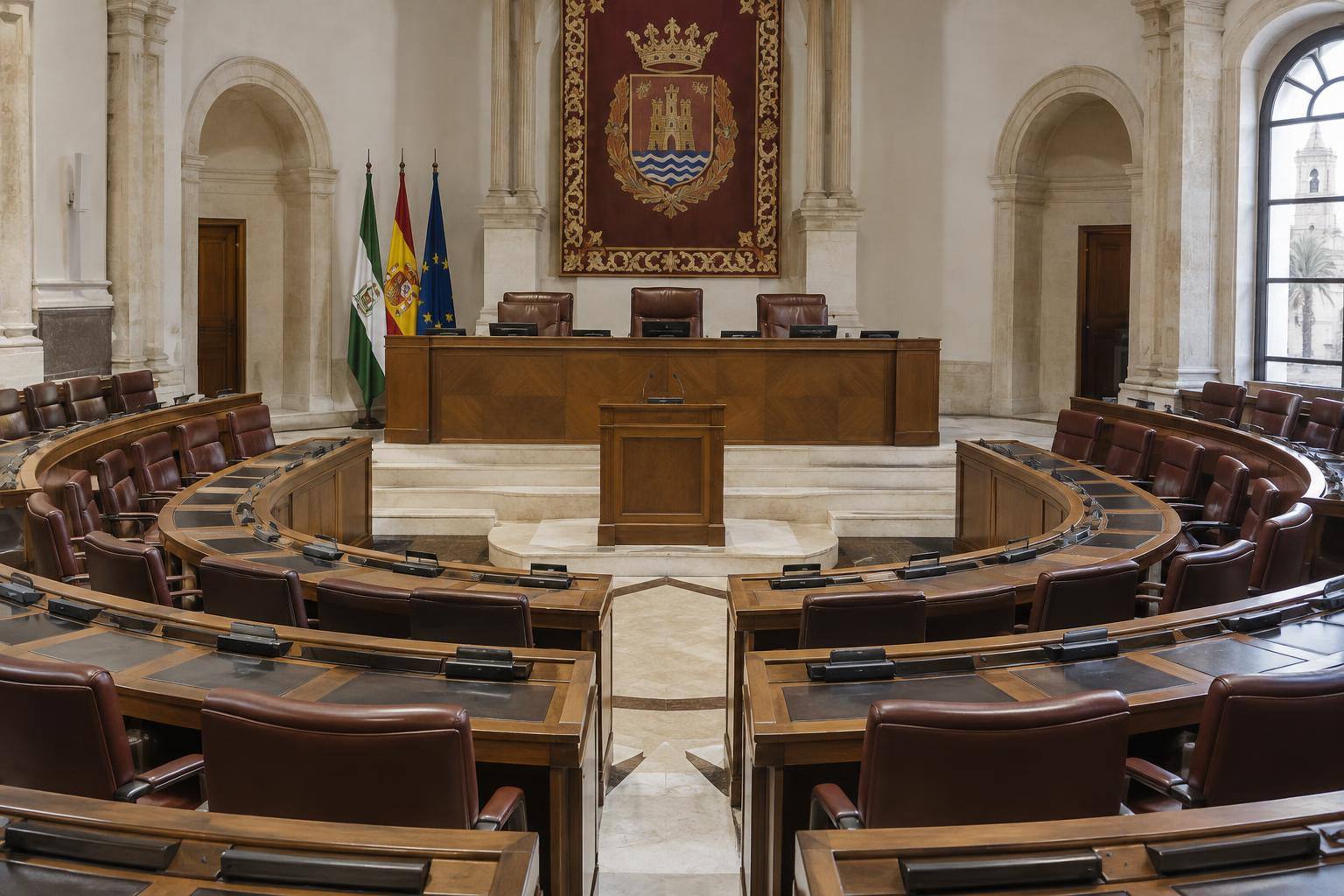 Imagen ilustrativa: Hemiciclo parlamentario vacío con escaños y una tribuna de intervención, sin personas ni símbolos partidistas.
